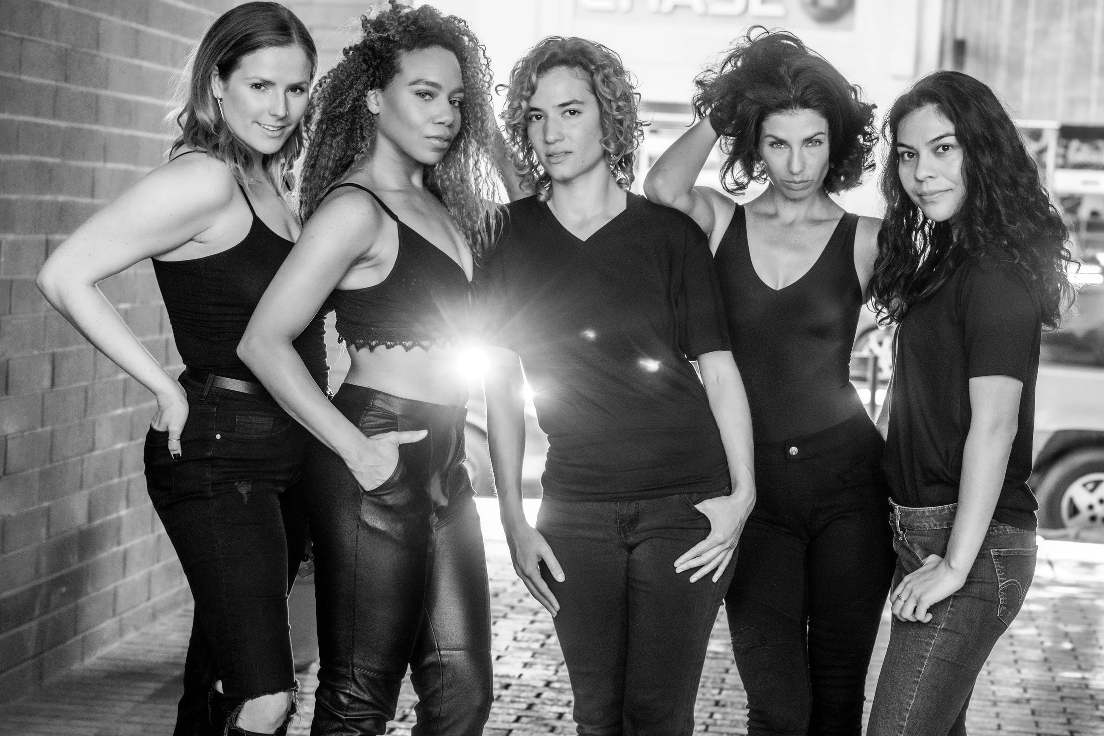 Daisi Jo with fellow models in a black-and-white street fashion editorial