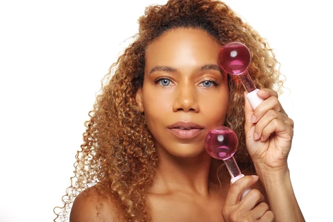 Daisi Jo — skincare portrait holding pink cooling globes