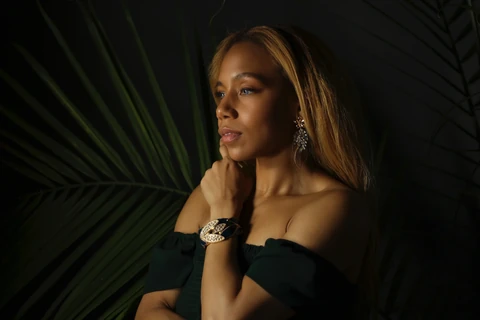 Daisi Jo — jewelry portrait against dark green palm leaves