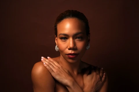 Daisi Jo — jewelry portrait with a hand resting on her shoulder