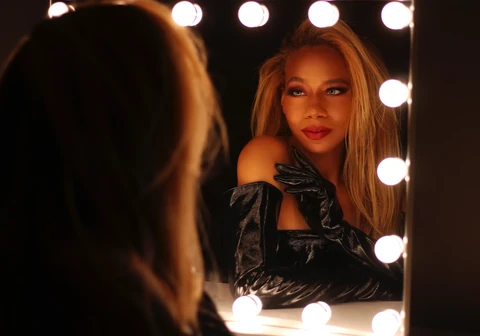 Daisi Jo — glamour portrait in black gloves beside a lighted mirror